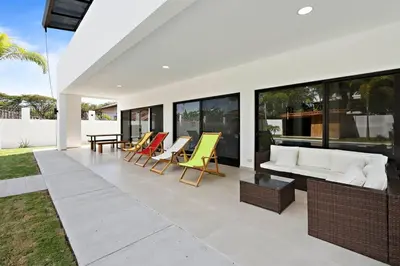 a living room with yellow chairs and a white couch at Casa Corales Dreams 1 in Playa Flamingo