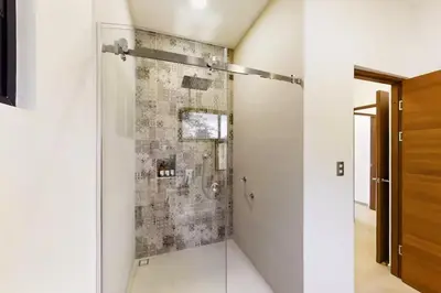 a bathroom with a shower with a glass door at Casa Corales Dreams 1 in Playa Flamingo