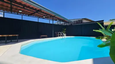a swimming pool in the backyard of a house at Mango Coliving Rooms for Digital Nomads in Uvita