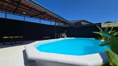 a swimming pool on the side of a building at Mango Coliving Rooms for Digital Nomads in Uvita