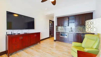 a living room with a flat screen tv and a couch at 360 Splendor 208F- Ocean View Condo, Breakfast in Playa Flamingo