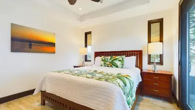 a bedroom with a bed and a painting on the wall at 360 Splendor 208F- Ocean View Condo, Breakfast in Playa Flamingo