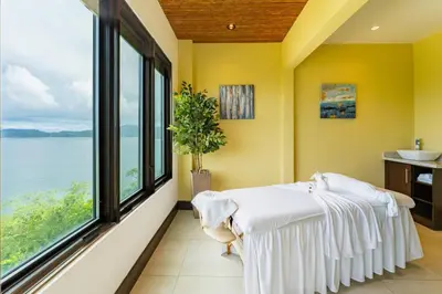 a room with a bed and a large window at 360 Splendor 208F- Ocean View Condo, Breakfast in Playa Flamingo