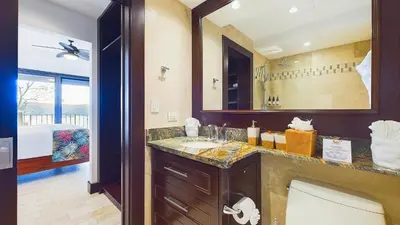 a bathroom with a sink and a large mirror at 360 Splendor 208A- Ocean View Condo, Breakfast in Playa Flamingo