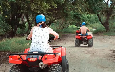 two people riding on atvs on a dirt road at 360 Splendor 208A- Ocean View Condo, Breakfast in Playa Flamingo