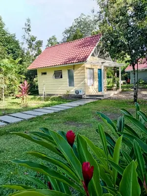 a small yellow house with a red roof at Casita Bohemia natural paradise in Peje Viejo