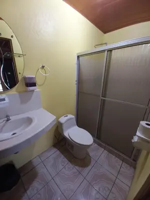a bathroom with a sink and a toilet and a shower at Cabinas Ruma in Muelle