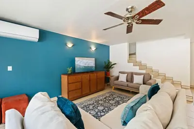 a living room with a couch and a ceiling fan at Casa Oasis Beach Villa with Pool, Playa Grande in Santa Cruz