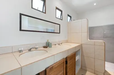a bathroom with a sink and a mirror at Casa Oasis Beach Villa with Pool, Playa Grande in Santa Cruz