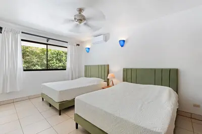 a bedroom with two beds and a window at Casa Oasis Beach Villa with Pool, Playa Grande in Santa Cruz