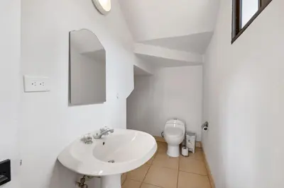 a white bathroom with a sink and a toilet at Casa Oasis Beach Villa with Pool, Playa Grande in Santa Cruz
