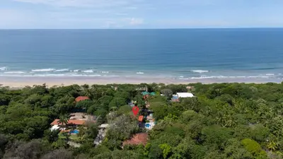 an aerial view of a house and the ocean at Casa Oasis Beach Villa with Pool, Playa Grande in Santa Cruz