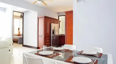 a dining room with a glass table and white chairs at Millys House 6p max Jacó CR in Jacó