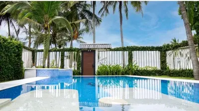 a swimming pool with palm trees and a fence at Millys House 6p max Jacó CR in Jacó