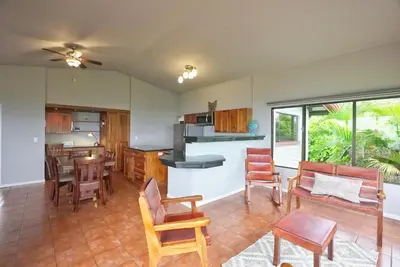 a kitchen and living room with a table and chairs at Villas Aracari beautiful upscale homes with amazing views near SJO airport in Pilas