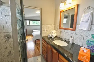 a bathroom with a sink and a mirror at Villas Aracari beautiful upscale homes with amazing views near SJO airport in Pilas