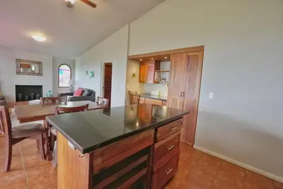 a kitchen and living room with a table and chairs at Villas Aracari beautiful upscale homes with amazing views near SJO airport in Pilas