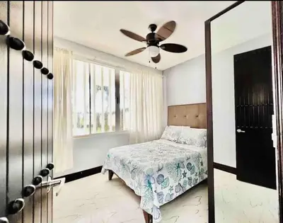 a bedroom with a bed and a ceiling fan at Millys house 12p max Jacó CR in Jacó