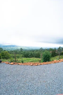 a rock wall on the side of a road at Cabaña Con Hermosa vista y ambiente de campo in Miravalles