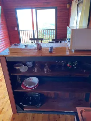 a wooden shelf in a kitchen with dishes on it at Cabaña Con Hermosa vista y ambiente de campo in Miravalles