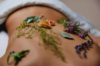 a woman with a bunch of flowers on her stomach at Hacienda AltaGracia, Auberge Collection in Santa Elena