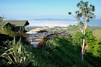 a resort with tables and umbrellas on a hill at Hacienda AltaGracia, Auberge Collection in Santa Elena