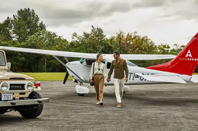 a man and woman walking towards a small plane at Hacienda AltaGracia, Auberge Collection in Santa Elena