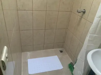 a bathroom with a shower with a toilet and a sink at Pinky s Place Alajuela City Airport Costa Rica in Alajuela City
