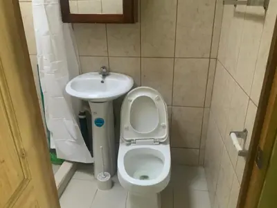a small bathroom with a toilet and a sink at Pinky s Place Alajuela City Airport Costa Rica in Alajuela City