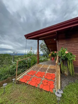 a house with a walkway with red tiles on it at Villa Lomas Sarapiquí in Colonia Carvajal