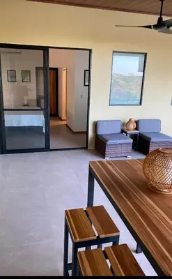 a living room with a couch and a table at Finca Quietud in Tarcoles