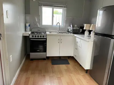 a small kitchen with a stove and a sink at Beautiful tiny house with AC WIFI in Santa Cruz