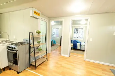 a kitchen with a stove top oven in a room at Beautiful tiny house with AC WIFI in Santa Cruz