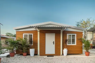 a small wooden house with a white door at Beautiful tiny house with AC WIFI in Santa Cruz