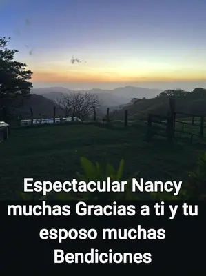 a view of a field with a fence and mountains at Sunset Farms and Waterfalls! in Tilarán