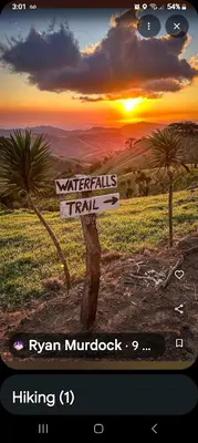 a sign that says waterfalls trail and a sunset at Sunset Farms and Waterfalls! in Tilarán