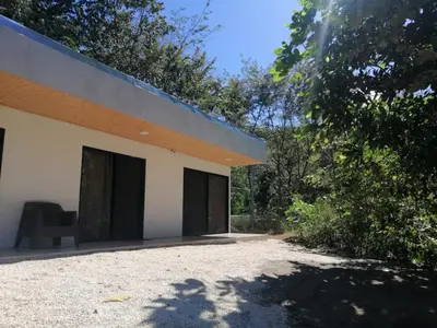 a building with black doors and a chair sitting outside at Apartamento JOKO in Villarreal