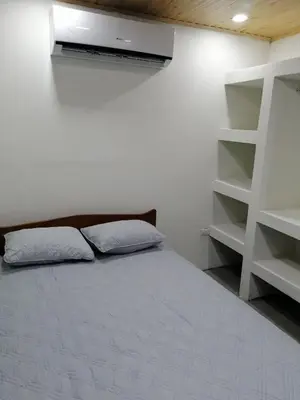a bedroom with a bed and a book shelf at Apartamento JOKO in Villarreal