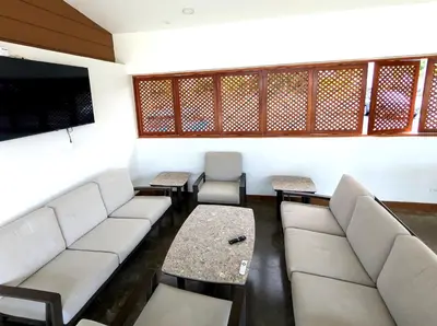 a living room with a couch and a table at Modern Paradise Relax & Explore at Viva Jaco in Jacó
