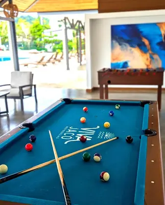 a pool table with billiard balls on top of it at Modern Paradise Relax & Explore at Viva Jaco in Jacó