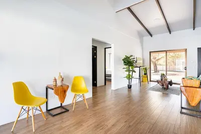 a living room with yellow chairs and a table at Quinta Bella in Bagaces