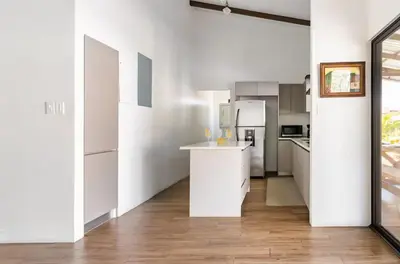a kitchen with white cabinets and a counter top at Quinta Bella in Bagaces