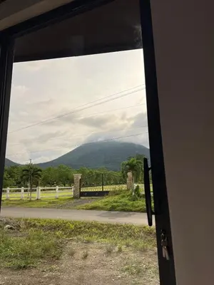a view of a mountain through a door at Epic Arenal View House in Fortuna