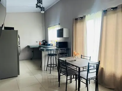 a small kitchen with a table and chairs in a room at Epic Arenal View House in Fortuna