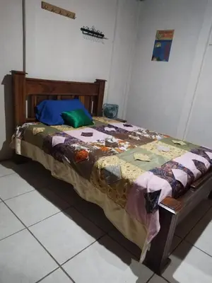 a bed sitting in a room with at La posada Escondida in Morazán