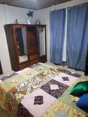 a bedroom with a bed with a quilt on it at La posada Escondida in Morazán