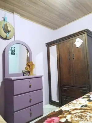 a bedroom with a dresser and a mirror at La posada Escondida in Morazán