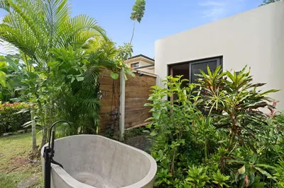 a bath tub in a garden next to a house at 4 BD Tranquil Villa in Playa Grande