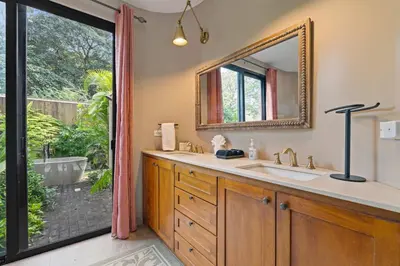 a bathroom with a sink and a mirror and a tub at 4 BD Tranquil Villa in Playa Grande