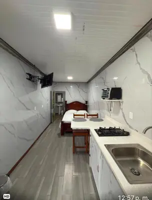 a kitchen with a sink and a bed in a room at Apartamento doña Lety in Fortuna